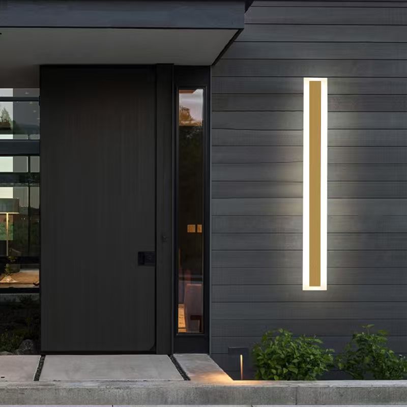 Gold 2001G linear outdoor wall light installed beside a modern entrance