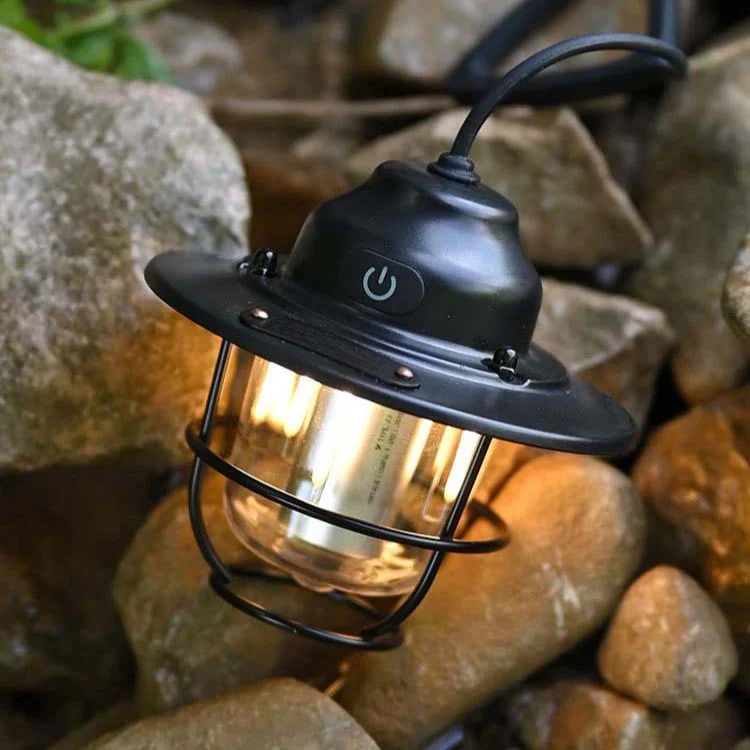 Real Dusk Black retro pendant lantern illuminated among outdoor rocks